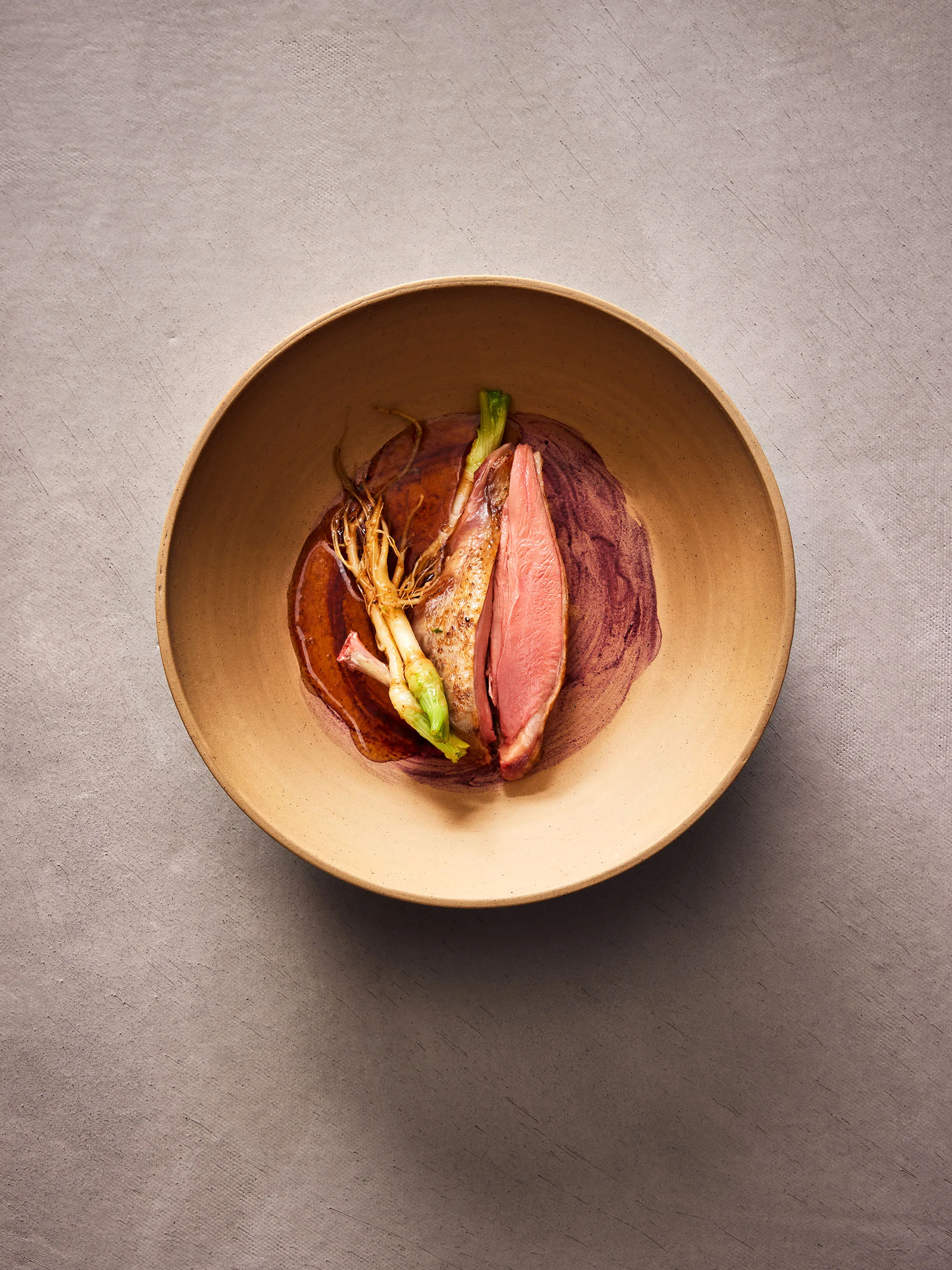 Rezeptbild "Taubenbrust - Fliederblüten - Korianderwurzeln - Taubenfond" aus dem Standardwerk "Sous-Vide" des Kochbuchautoren Heiko Antoniewicz